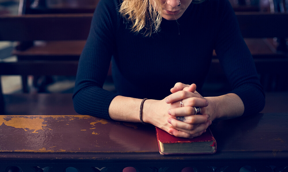 Woman in church with bible